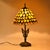 In incredible and unique statement lamp that features an antique gold cast iron double cherub lamp base and a handmade...