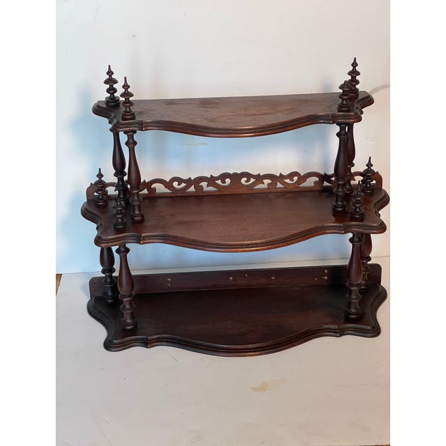 Vintage 3 tier cascading wall shelf with fret work and decoration. Great display piece.