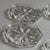 A striking set of five vintage clear glass coasters featuring a crisp octagonal silhouette and an elegant molded twelve-...