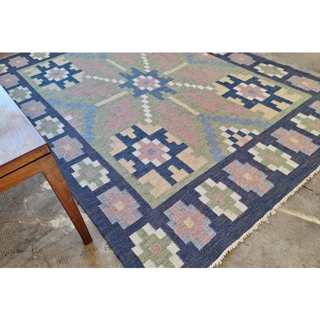 Mid century original hand-woven Scandinavian flatweave kilim in wool with natural soft colors including greens and navy...