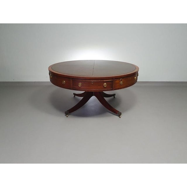 Mahogany Victorian " Heldense " Coffee table / Drum table with leather top on brass wheels. '80s Wide 112 Height 55 cm