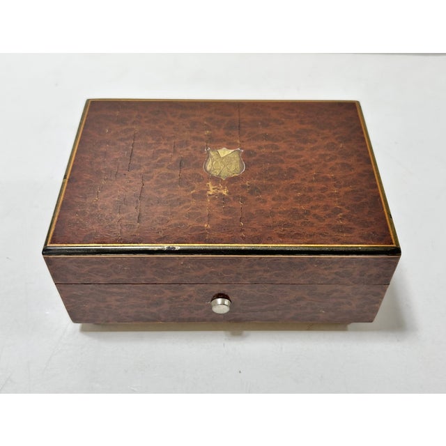 working vintage Reuge Sainte-Croix music box housed in a richly figured burl wood veneer case with brass-tone trim. A...
