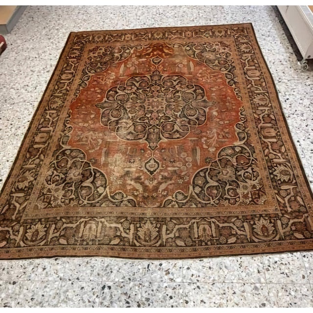 An exceptional antique Persian rug dating to the late 19th century, featuring a richly detailed central medallion set...