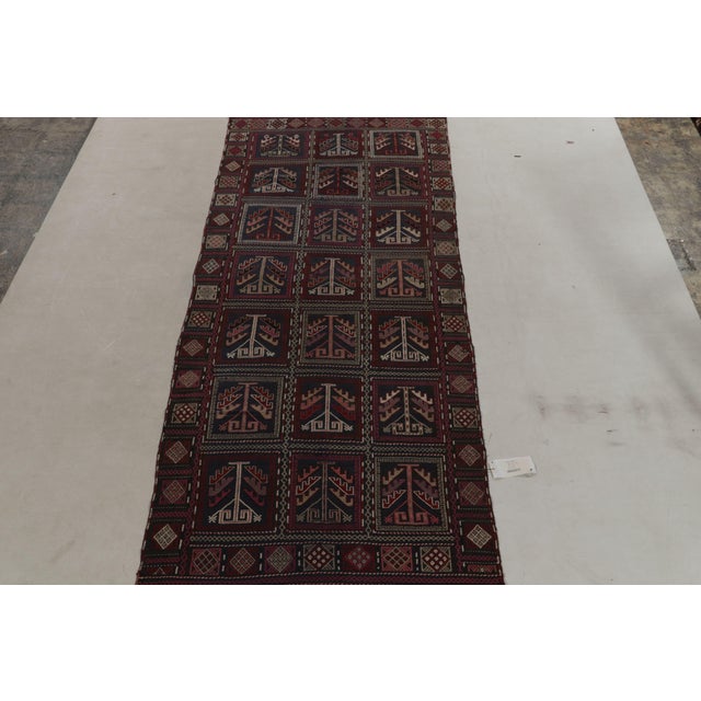 Originating between 1920-1930, a rare 4x10 antique Caucasian kilim rug believed to be of Russian tribal provenance....