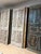 This striking pair of antique double entry doors is expertly hand-carved from solid wood and finished with a richly...
