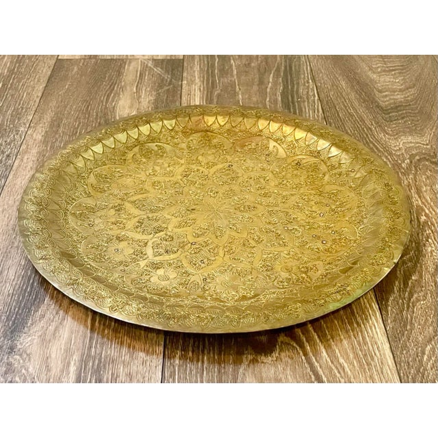 A highly crafted, vintage engraved and detailed Middle Eastern tray. Constructed of solid brass with intricate multi-...