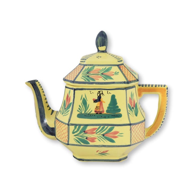 Mid 20th century French Quimper ceramic tea pot featuring the classic yellow ground glaze with traditional hand-painted...