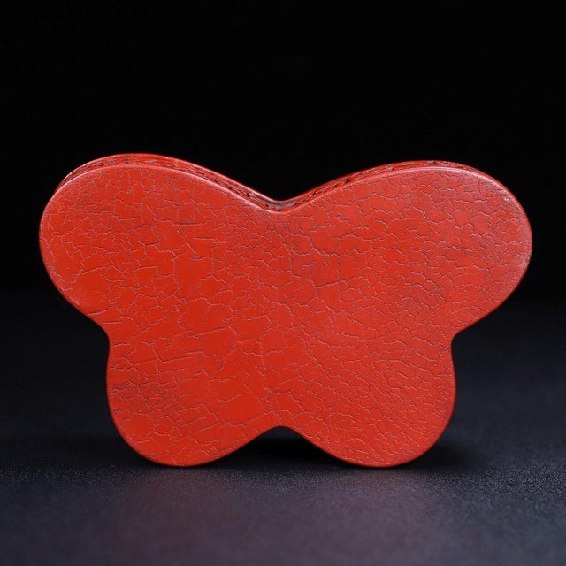 This elegant vintage Chinese butterfly-form cinnabar lacquer lidded box features deeply carved raised relief of plum...