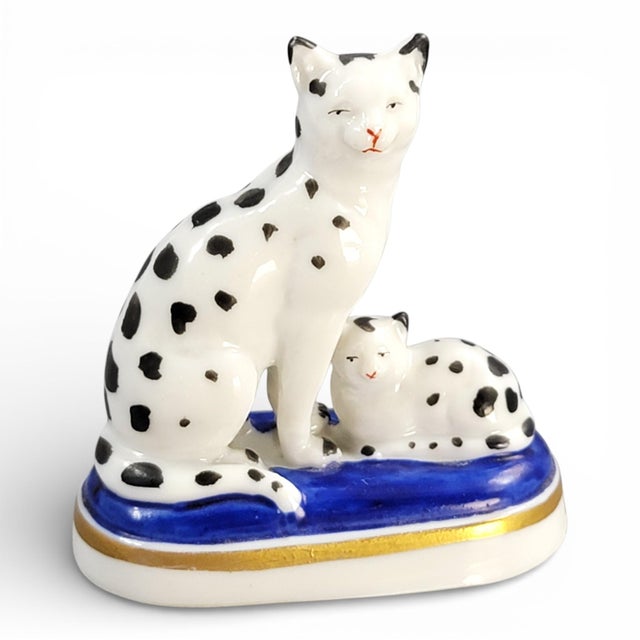 This rare porcelain miniature group, attributed to Chelsea and dating to the late 18th century, depicts a seated spotted...