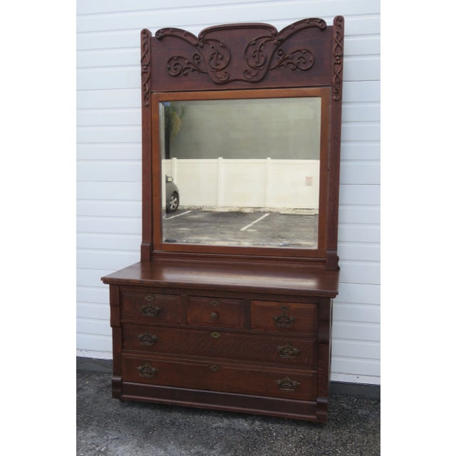 This Tall Dresser and Mirror made out of wood, solid wood, solid oak, solid tiger oak, and brass. The Dresser has...