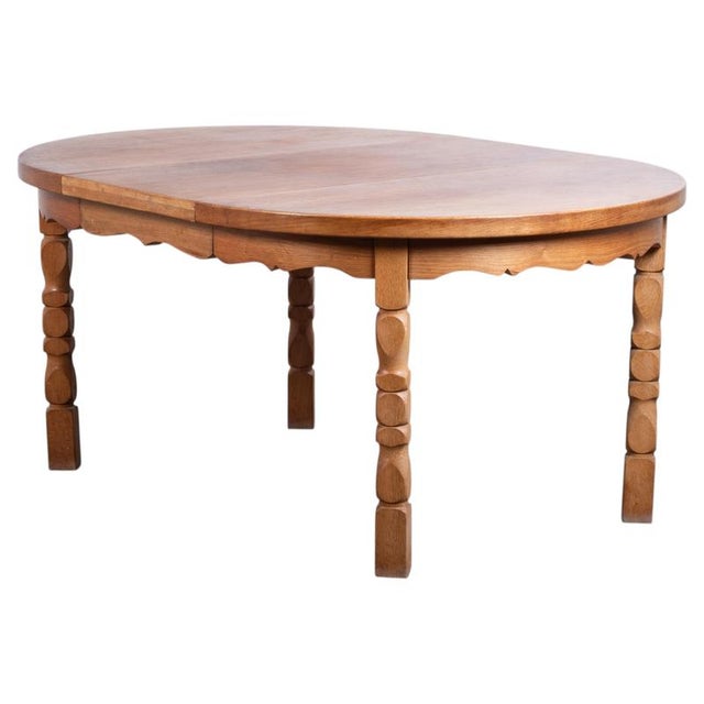 Round Brutalist dining table in solid oak, produced in Denmark during the 1960s. The table combines a robust, sculptural...