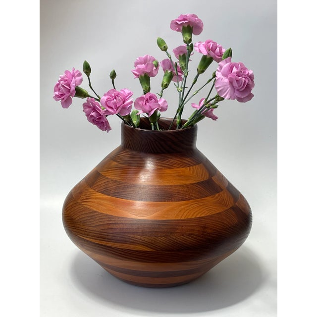 An expressive and masterfully American craftsman turned vessel crafted of multiple grained walnut. Period 1965 - 1969...