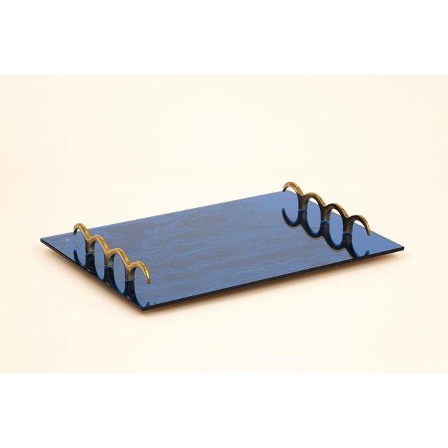 Blue mirrored glass tray with brass elements.