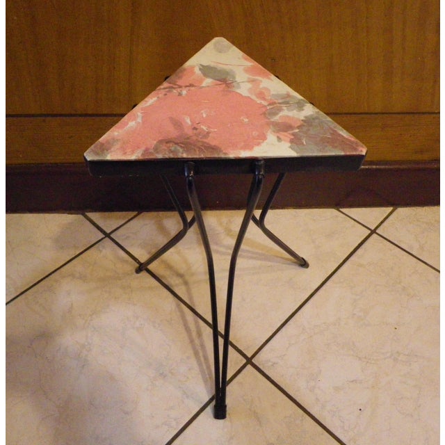 Side table. Tripod with a triangular top covered in pastel floral vinyl (23 x 23 x 23 cm). Height 37 cm. Black metal...