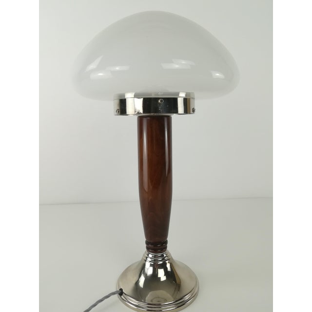 Frame made of solid walnut, lacquered. The nickel-plated surfaces are polished. The luminaire has been rewired according...