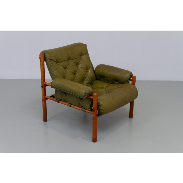Scandinavian Mid-Century Modern Arne Norell Easy Chair, Sweden 1970s. Safari Chair in green leather, stained beech and...
