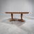 A large oval table made around the middle of the last century with details reminiscent of neoclassical lines....