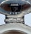 A sculptural vintage decanter with a rounded clear-glass body, starburst-cut base, and distinctive angular silver-plate...