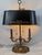 A beautifully crafted vintage Wildwood bouillotte-style table lamp featuring a solid brass-tone frame, elegant black...