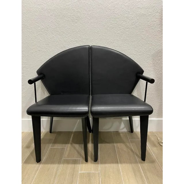 Chic Modern set of four Italian leather Dining chairs. Super cool looking sleek black finish. Attribute of Italian...