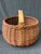 Large antique hand woven willow basket with a top double spliced branch handle. There is a bit of loose bark on the...