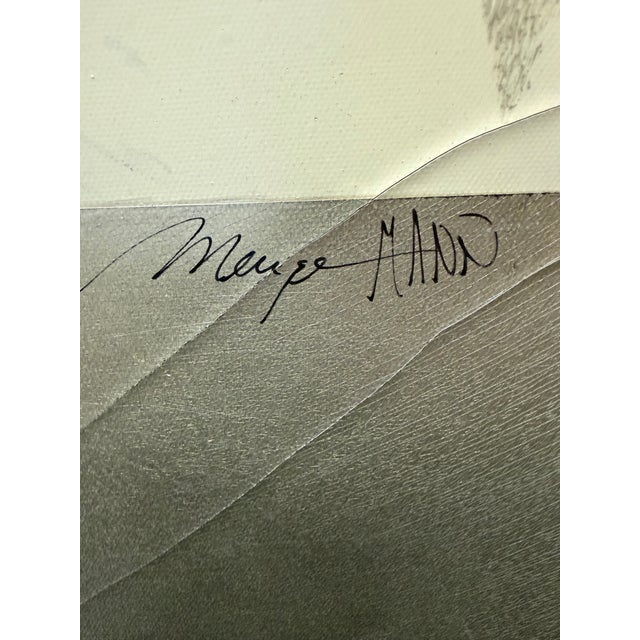 This contemporary mixed-media artwork features layered textures and metallic tones with delicate leaf silhouettes drifting...