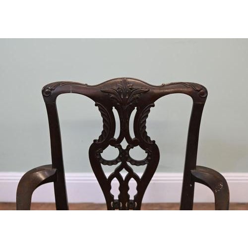 Handsome Victorian mahogany armchair in the Chippendale style, circa 1890. The shaped crest rail features carved foliage...