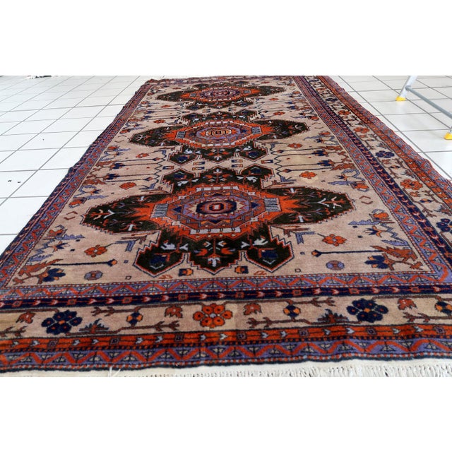 Handmade vintage Caucasian Kazak rug in traditional medallion design. The rug is from the middle of 20th century in...