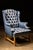 This gorgeous tufted leather chair boasts a rich midnight blue hue and gold accent buttons. Featuring a wide, comfortable...