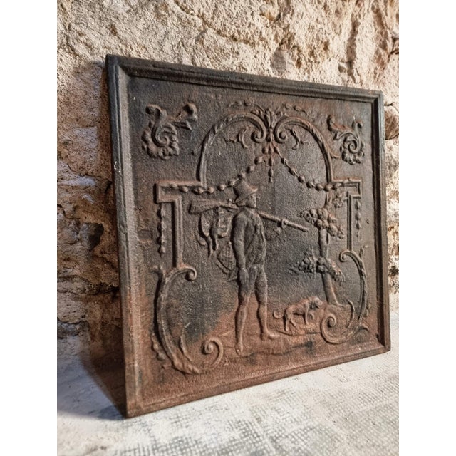 Antique French fireback crafted from solid cast iron and dating from the 18th century. Traditionally used at the back of a...