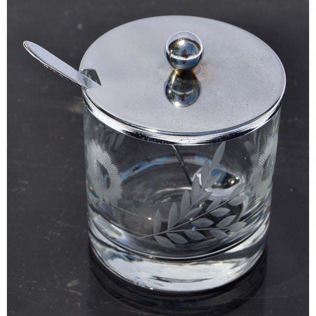 1940s Flemington etched jelly jar with spoon is an elegant and collectible kitchen piece, featuring etched glass or...