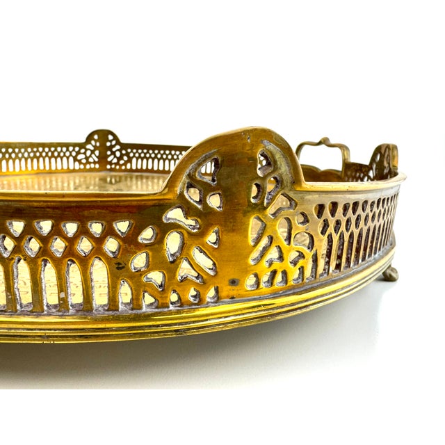 Elegant French gilt brass tray with a finely pierced gallery rim featuring repeating geometric and foliate motifs,...