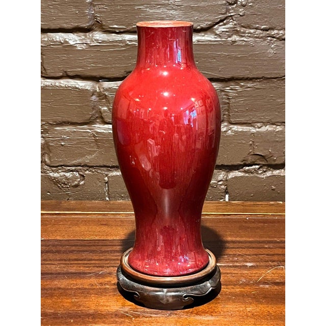 Exceptional Chinese monochrome porcelain baluster-form vase rendered in a rich Sang de Boeuf (oxblood) copper-red glaze....