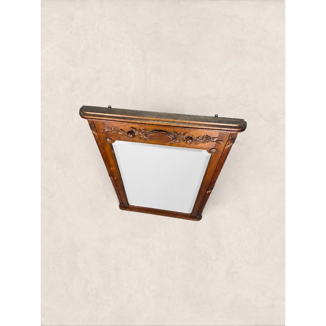 Antique Carved Ornamental Wall Mirror Heavily carved with floral motifs that reward a closer look, this French revival...