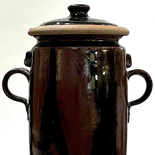 Hand-crafted stoneware pottery jar With two handles on either side. Topped by a unique "mushroom" lid. Exterior is glazed...
