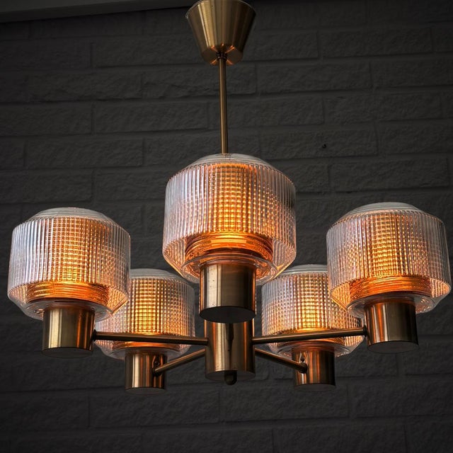 A Scandinavian Modern chandelier produced by an unidentified Swedish manufacturer in the 1960s. Crafted from solid brass,...