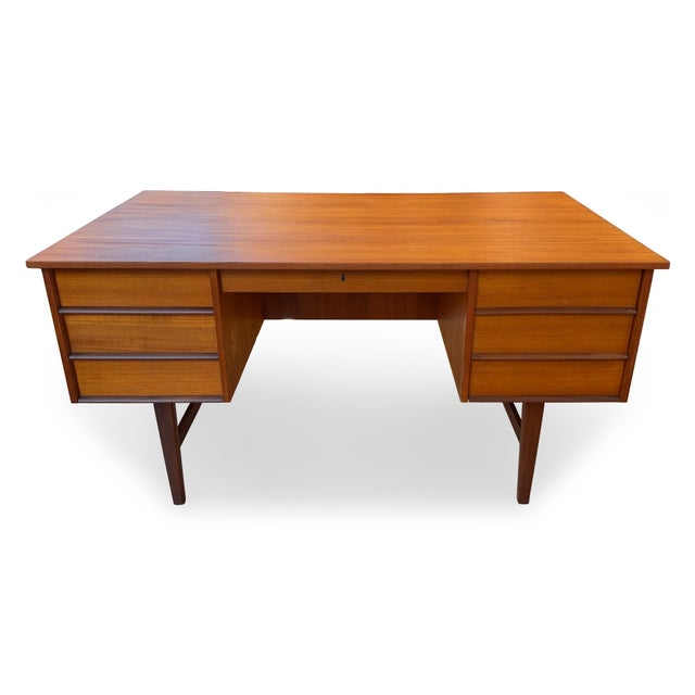 1960s Danish Modern teak executive desk. With its clean lines, solid construction, and generous workspace, this is a...