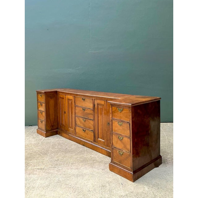 This monumental English sideboard is a masterpiece of traditional cabinetry, featuring a unique recessed-center breakfront...