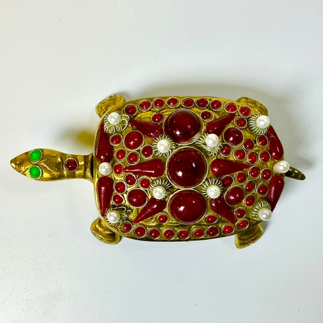 This vintage brass turtle box is enhanced with bejeweled beads in a deep ruby red and faux pearls. He is just lovely and...