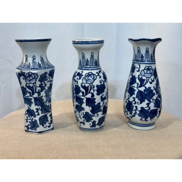 Beautiful set of 3 antique hand painted vases with stylized dense blue and white scrolling foliage decoration on body and...