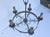 Circa 1910 Gothic Renaissance Revival Iron Chandelier with original antique patina and candle covers.