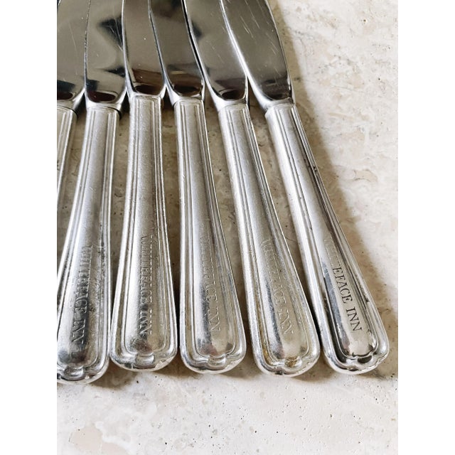 A set of eight lovely antique circa early 1900s silver plated butter knives with stainless blades from the historic...