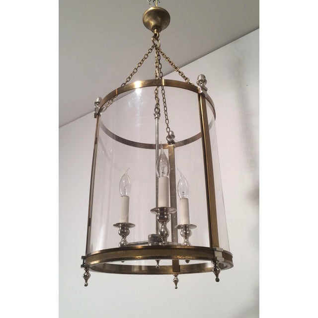 This neoclassical large lantern is made of brass and silver plated with strong plastic rounded faux-glass. This is a...