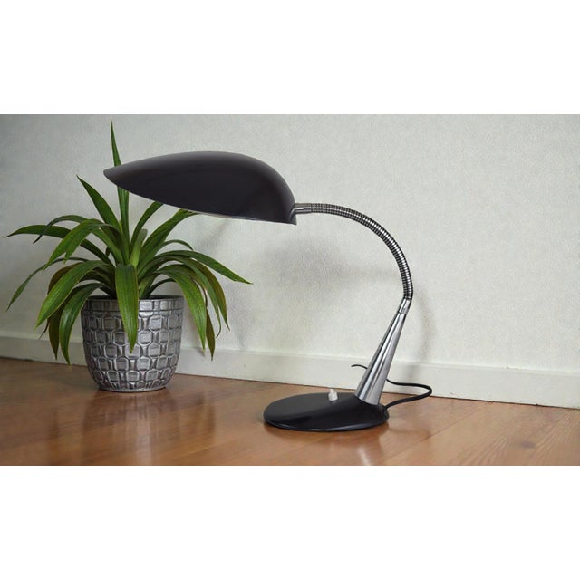 Cosack desk lamp, 1950s Manufacturer: Gebruder Cosack Oval base in black cast iron. Conical stem/tube in chromed brass....