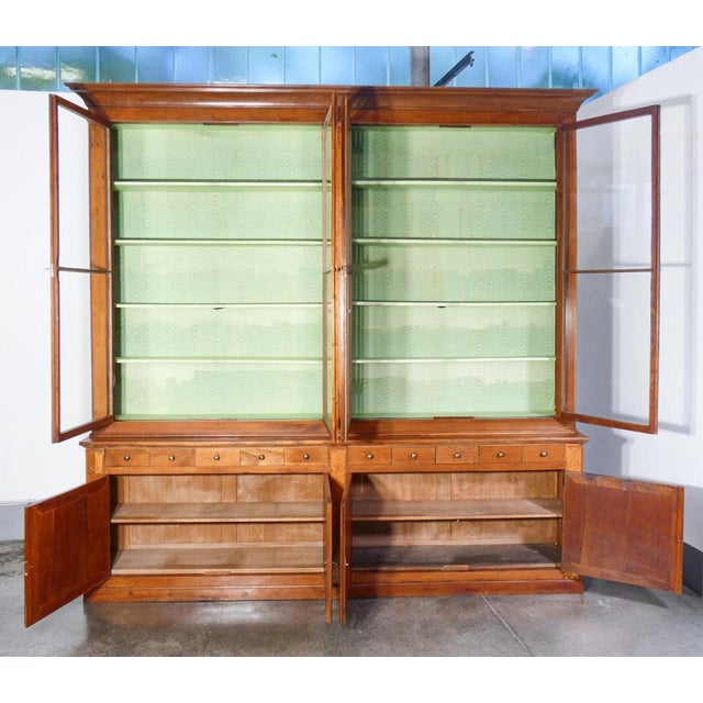 Large bookcase, pharmacy cabinet in solid cherry wood inlaid with maple. Double-body piece of furniture composed of an...