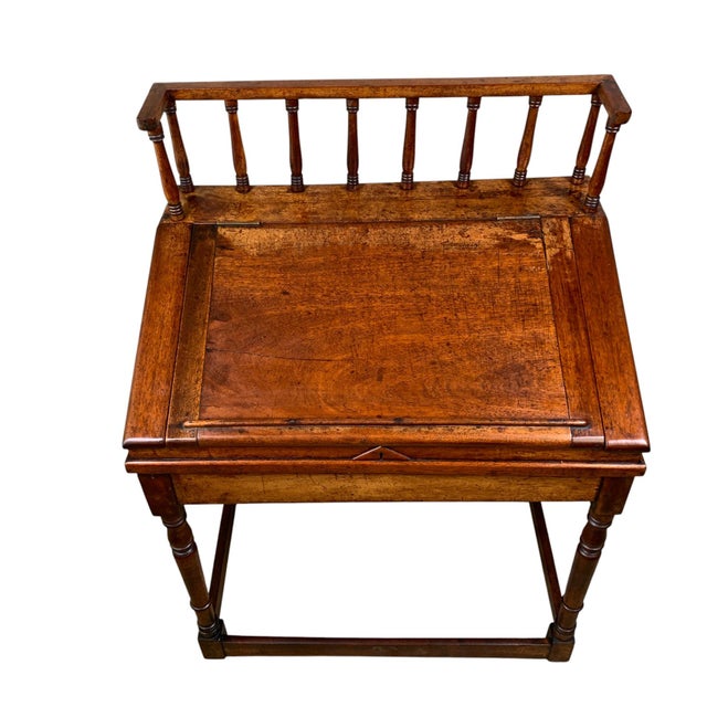 This Pennsylvania Walnut Slant Top Desk features two-piece construction, with a high gallery supported by turned spindles,...