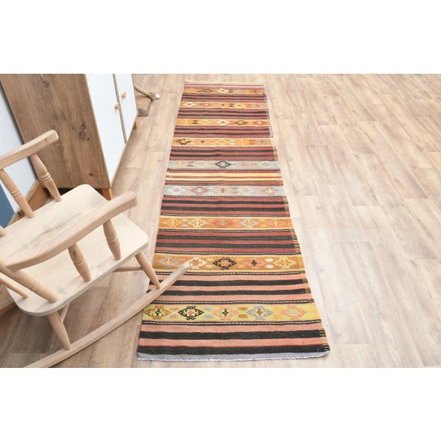 Vintage Turkish Hand-Knotted vintage rug is a semi- vintage runner rug.'70s Eastern region of Turkey's unique rug is...