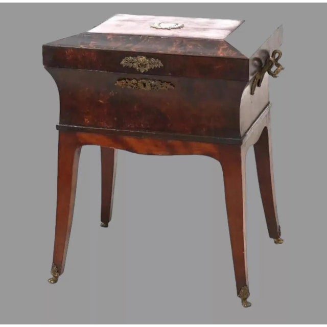 An antique French Louis XVI sewing box or jewel chest with olive wood and mahogany, hinged faceted lid having applied...