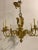 A circa 1920's Caldwell gold plated finish 8 lights chandelier, with cherubs atop