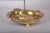 Brass bouillotte candle lamp with four candle holders in a round dished base on sculpted paw feet. Its included deep green...